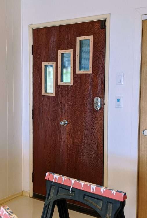 The inside of the Elaine door kit with reed glass during installation.