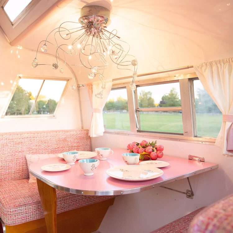 Vintage trailer restoration. Pink SparkleLam™ on the tabletop and counters accents the pink woven fabric of the booth seats.