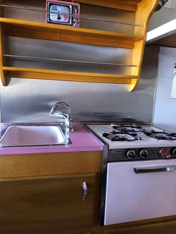 Vintage trailer restoration. Pink SparkleLam™ is used on the countertops, coordinating with the stove.