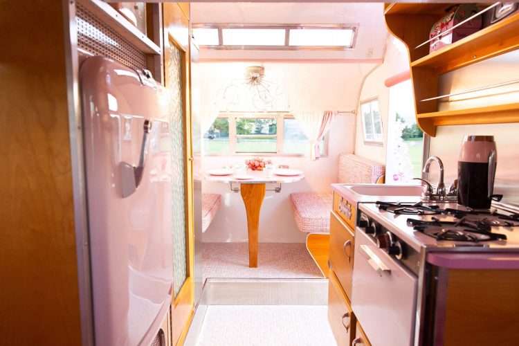 Vintage trailer restoration. Pink SparkleLam™ on the tabletop and counters accents the pink stove and refrigerator.