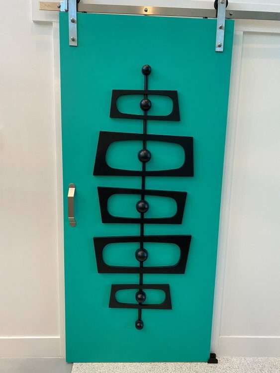 The Debbie Irene interior door kit in a private residence. The owner used modern sliding door hardware to mount the door in front of an existing opening.