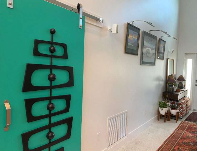 The Debbie Irene interior door kit in a private residence. The owner used modern sliding door hardware to mount the door in front of an existing opening.