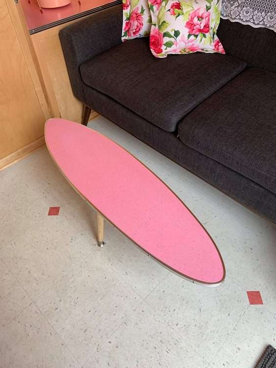 Vintage trailer restoration. Surfboard coffee table in pink SparkleLam™.