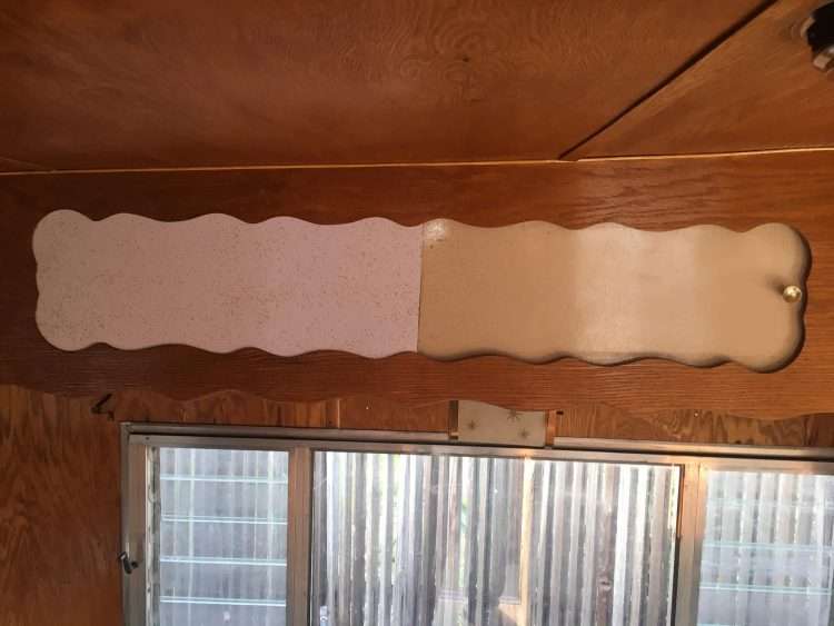 Vintage trailer restoration. This image shows the new white SparkleLam™ door with the yellowed original glitter laminate door on a storage cubby.
