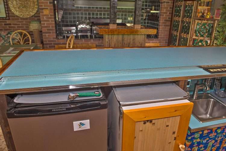 Tiki bar in a private home made by the homeowner. Countertops and drink tail in Light Aqua SparkleLam™.