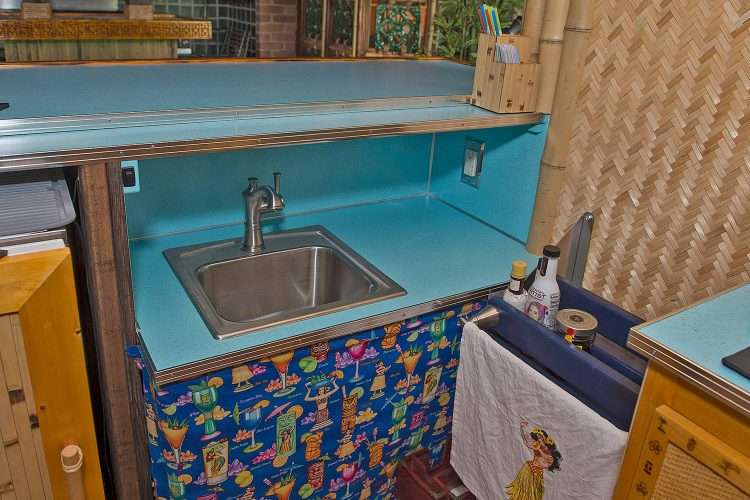 Tiki bar in a private home made by the homeowner. Under counter sink, drink rails, and countertops in Light Aqua SparkleLam™.