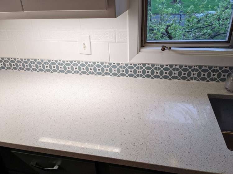 Custom color Flower decorative tile to match cabinet colors.